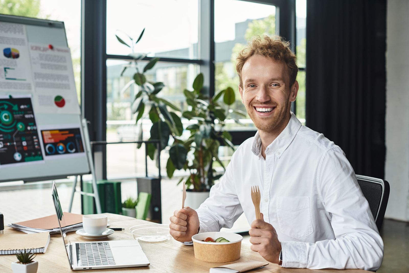 Office worker eating lunch from a kraft bowl