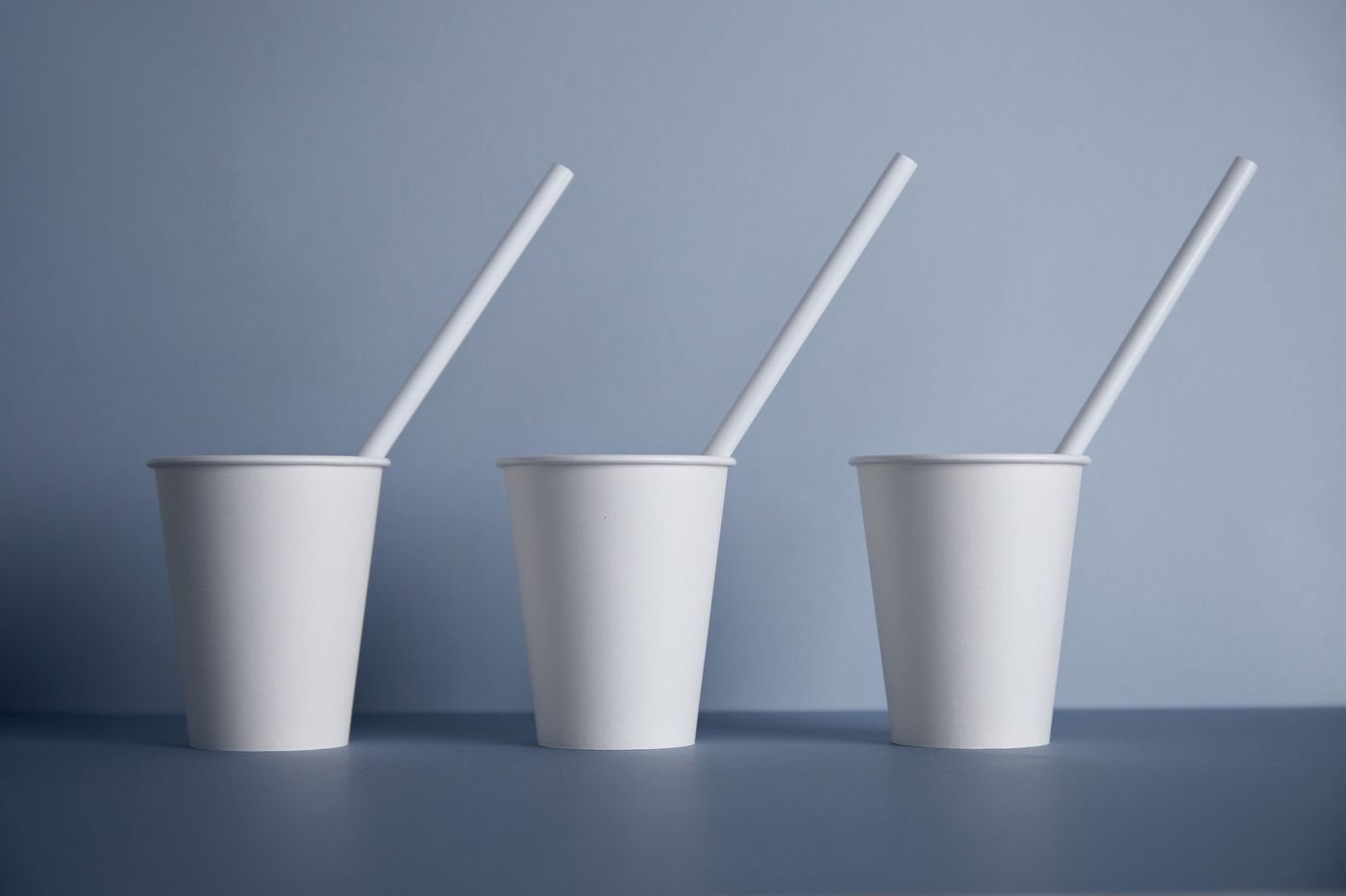 Paper cups with white paper straws