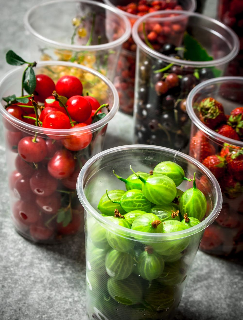 Clear plastic cups filled with fresh berries